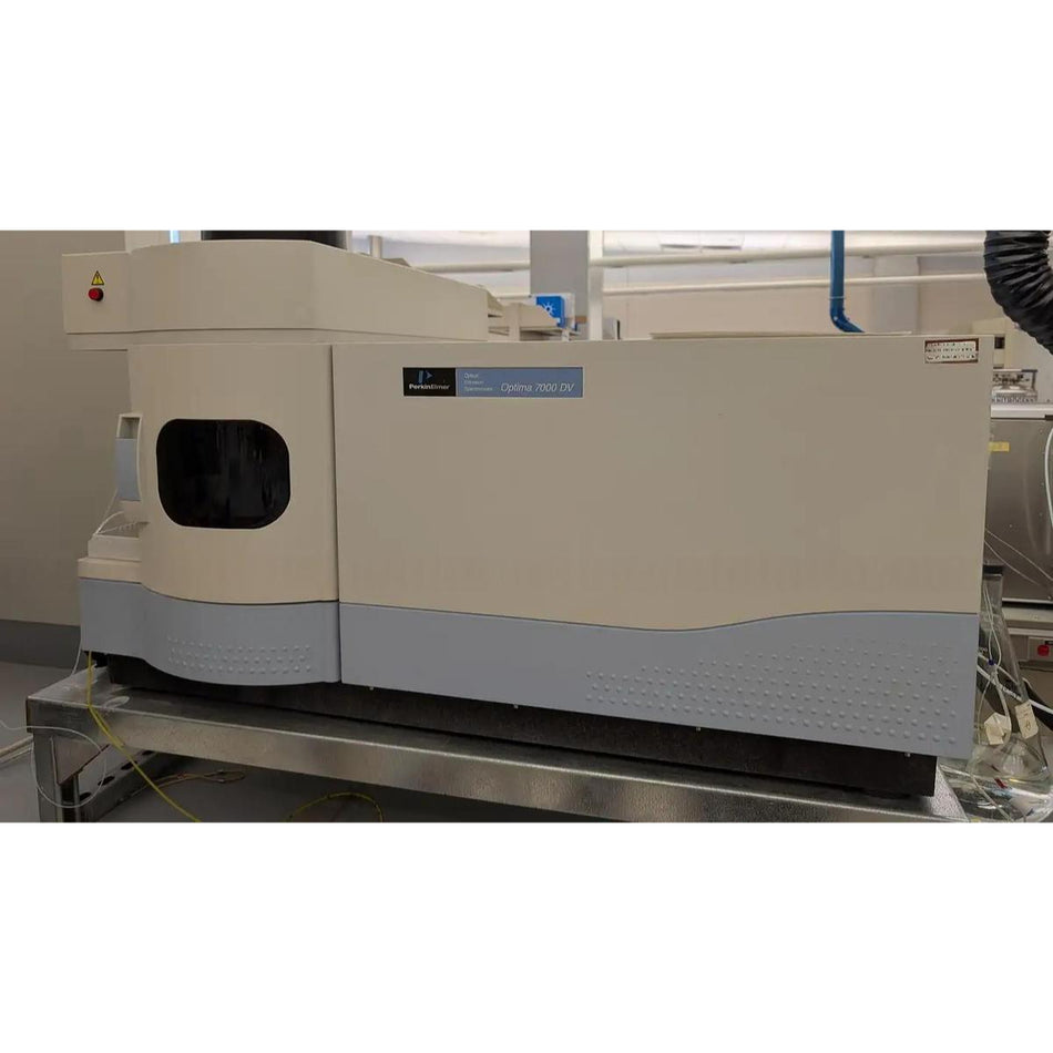 Used PerkinElmer Optima 7000 DV ICP-OES spectrometer (Part No. N0770780, Serial No. 080C0092103) sitting on a stainless steel lab bench in a clean laboratory environment, showing the beige and gray dual-view instrument housing with the PerkinElmer Optima 7000 DV model label on the front panel