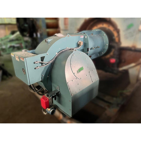 Cleaver Brooks 700HP industrial natural gas forced-draft burner assembly showing teal painted housing, combustion air fan, red emergency disconnect switch, and integrated control panel