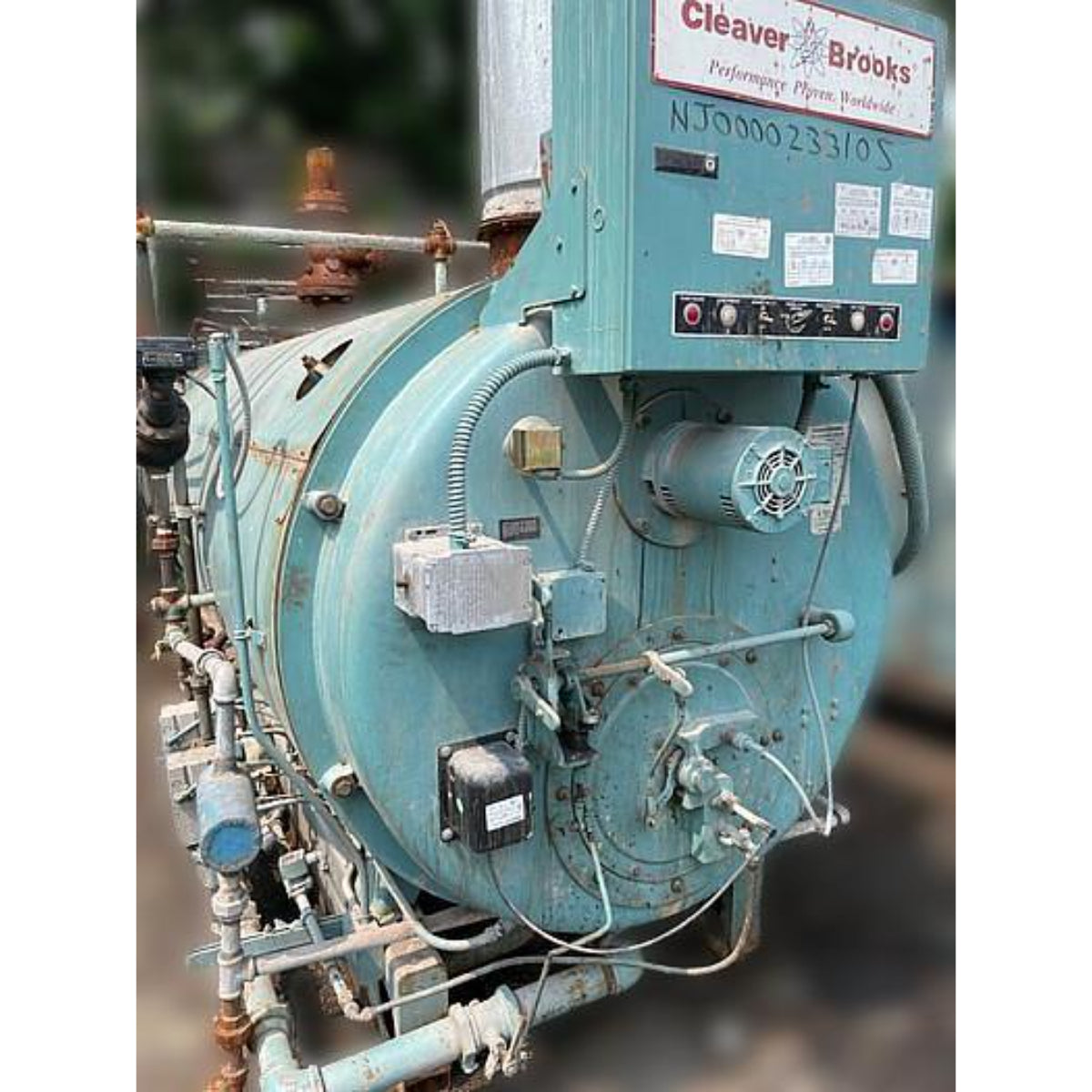 Teal industrial machine with 'Cleaver Brooks' branding on a blurred background