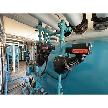 Industrial setting with blue pipes and machinery in a room.