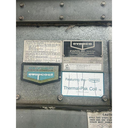 Metal surface with Evapco labels and text on a white background