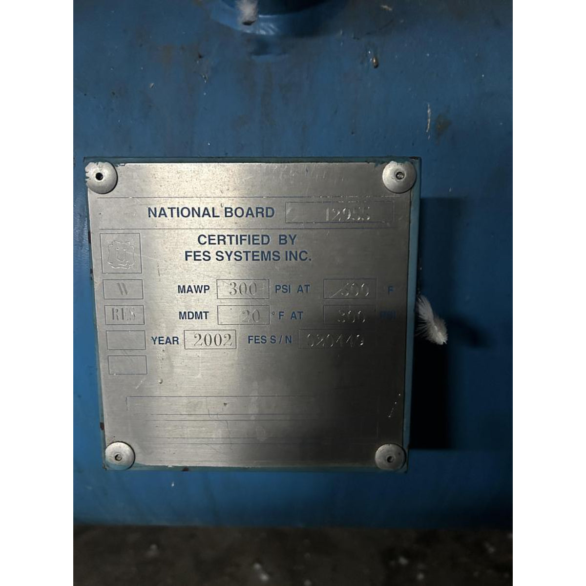 Metal certification plate on a blue background