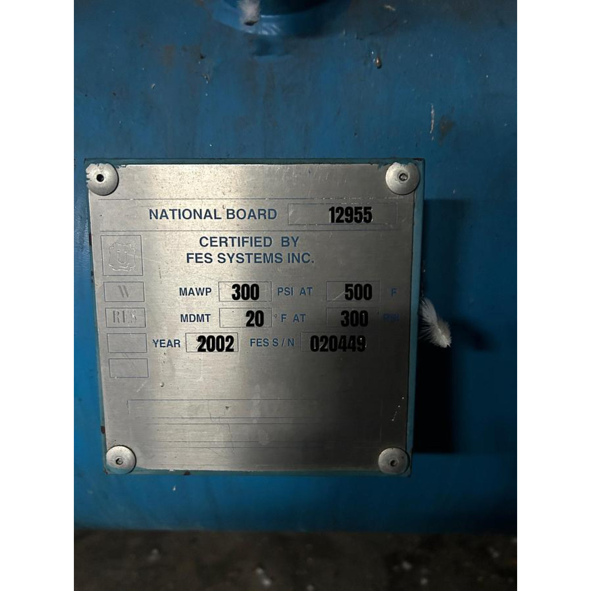Metal certification plate on a blue background