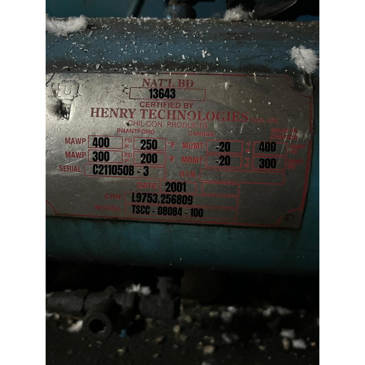 Metal component with technical specifications and branding on a dark background