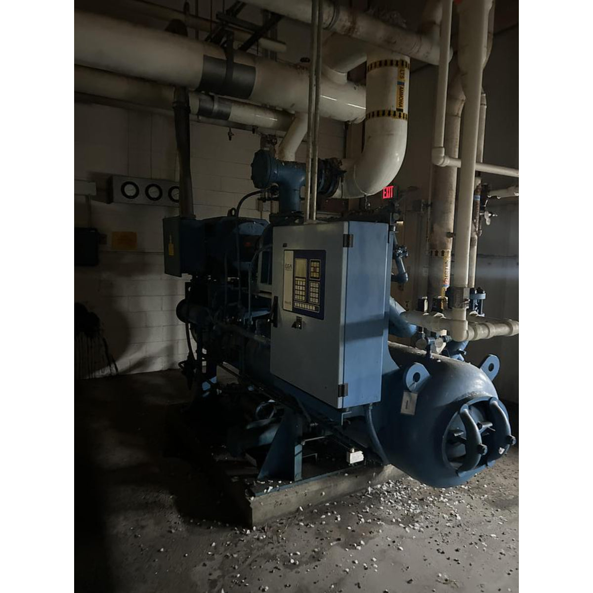 Industrial machinery with pipes in a dimly lit room