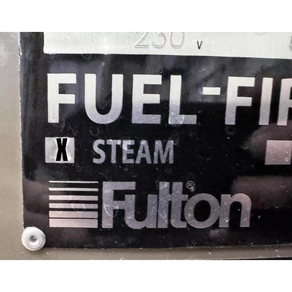 Fulton brand label on a mechanical component with 'Fuel-Fired Steam' text.