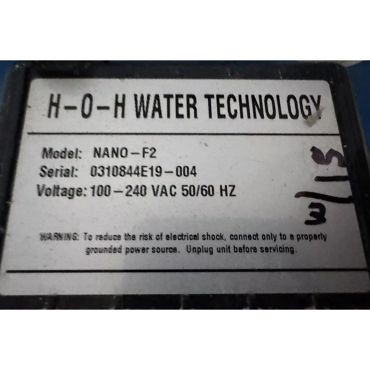 Technical label for H-O-H Water Technology device with model, serial, and voltage information.