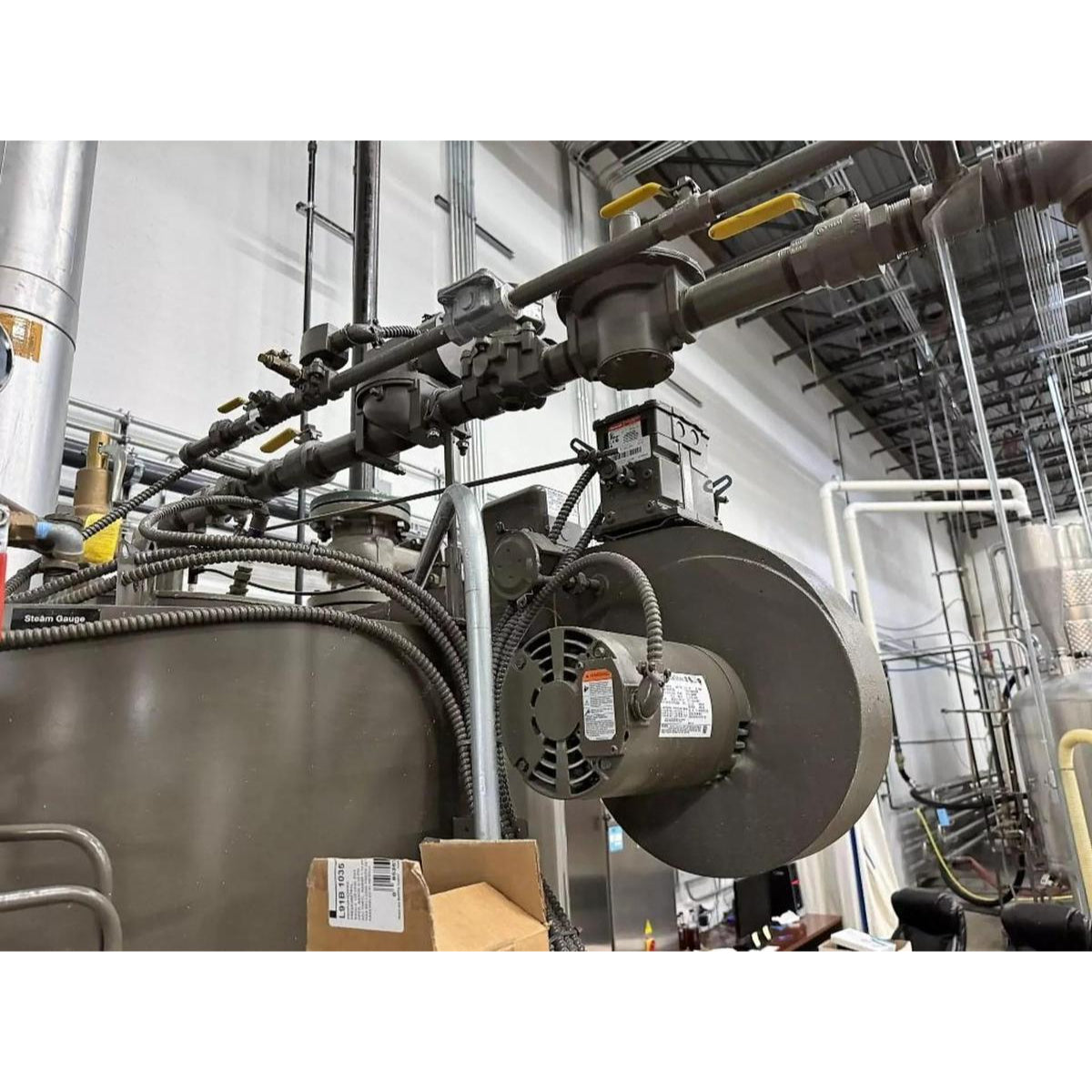 Industrial machinery with pipes and equipment in a factory setting