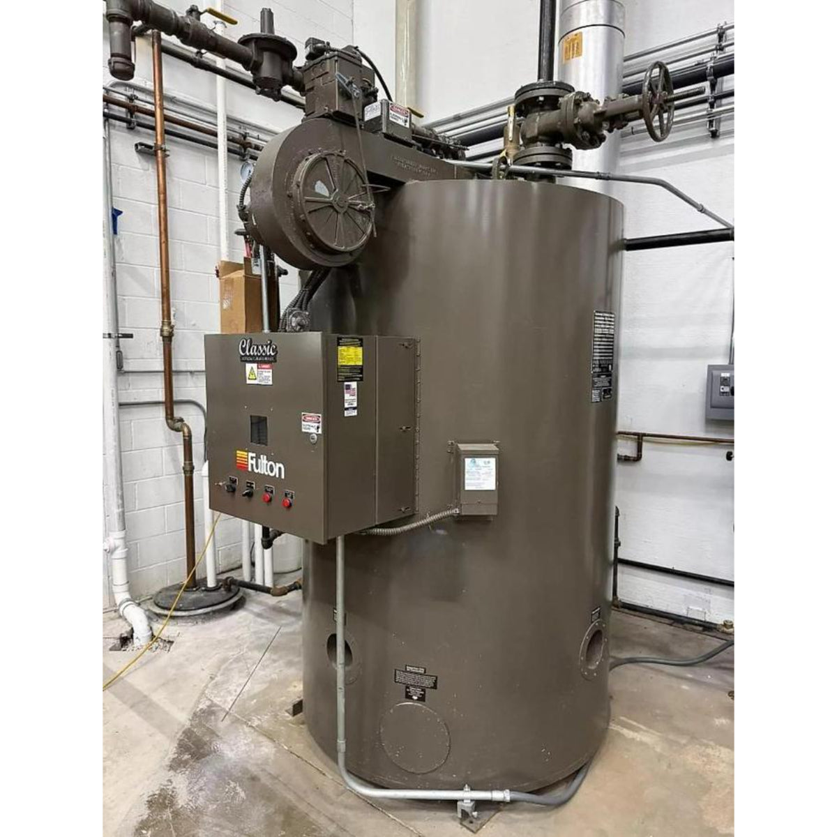 Large industrial boiler with visible branding in a mechanical room setting