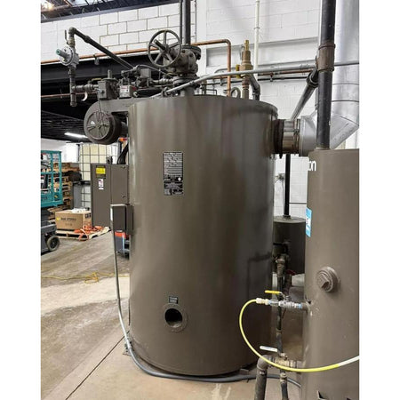 Large industrial storage tank with piping in a warehouse setting
