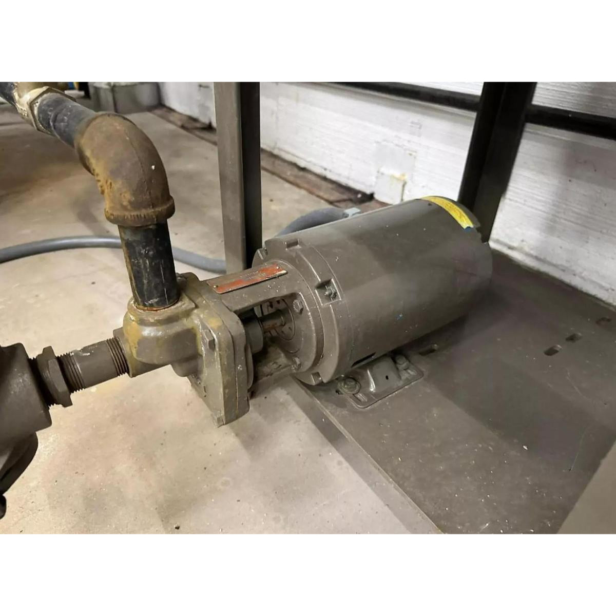 Industrial pump with piping on a concrete floor