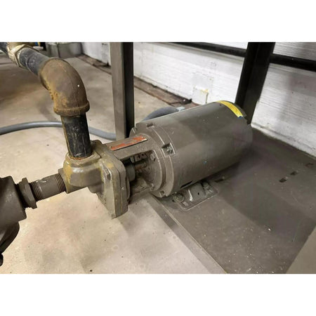 Industrial pump with piping on a concrete floor