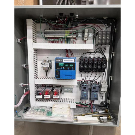 Electrical panel with various components and wiring inside a cabinet