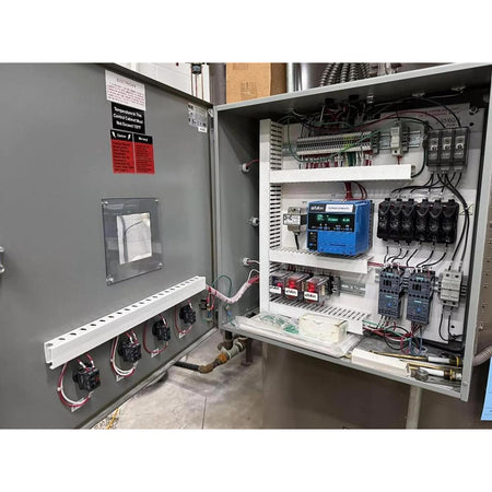 Electrical panel with various components and wiring inside a control cabinet.