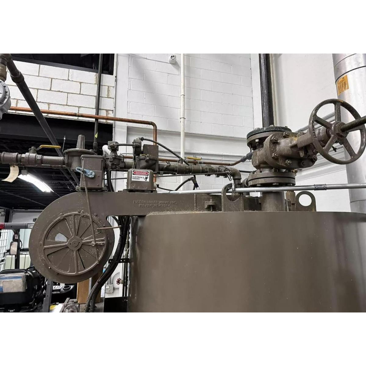 Industrial machine with various components in a workshop setting