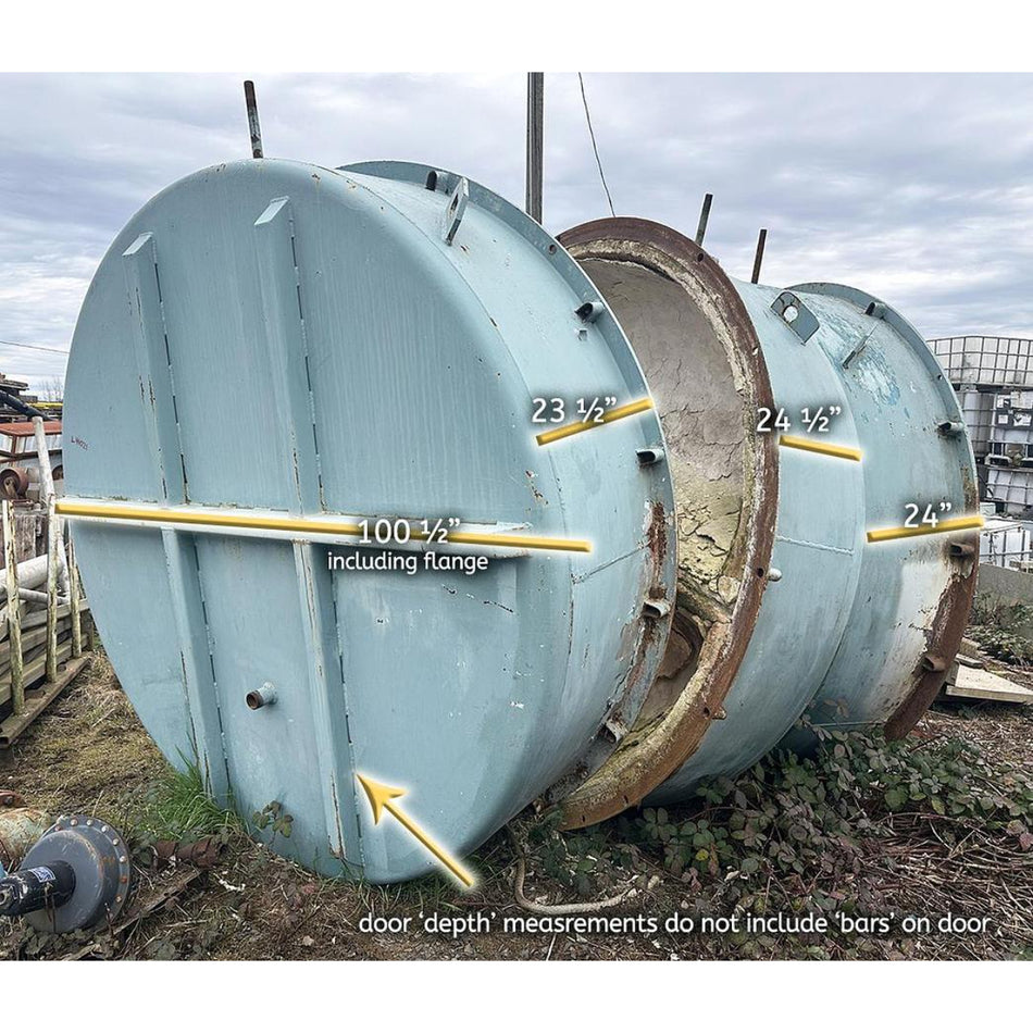 Large cylindrical metal tank with door open, showing measurements, on a cloudy day.