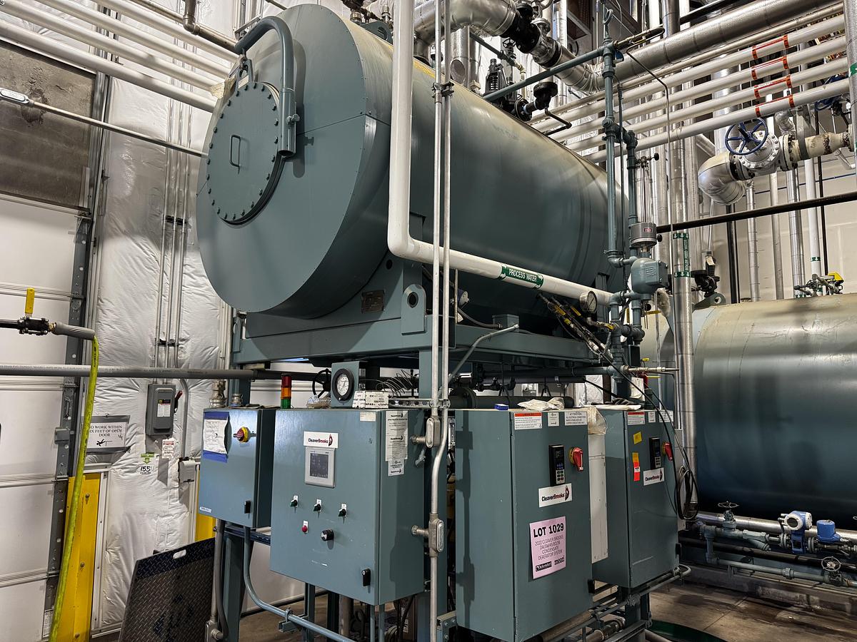 Large industrial boiler or heat exchanger with pipes and controls in a mechanical room.