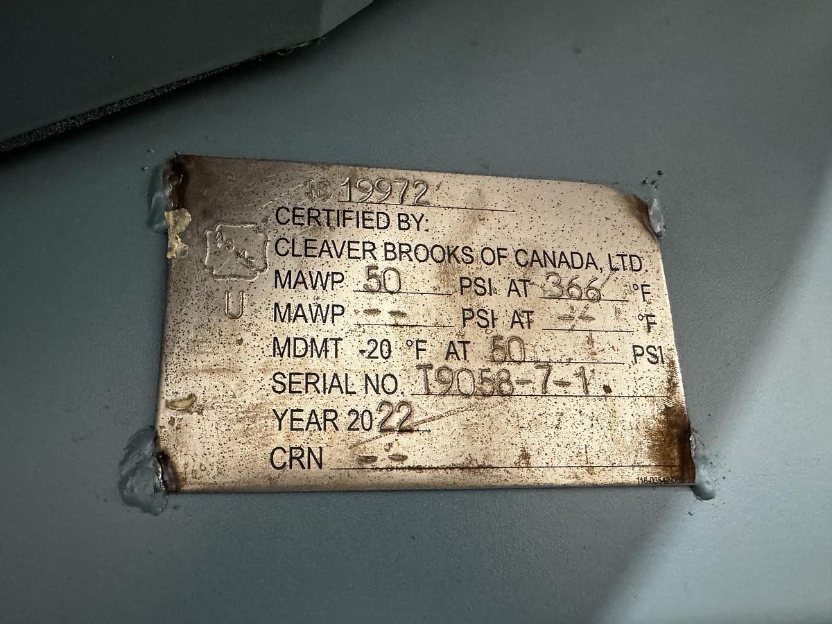Certification label on a metallic surface with text and numbers.