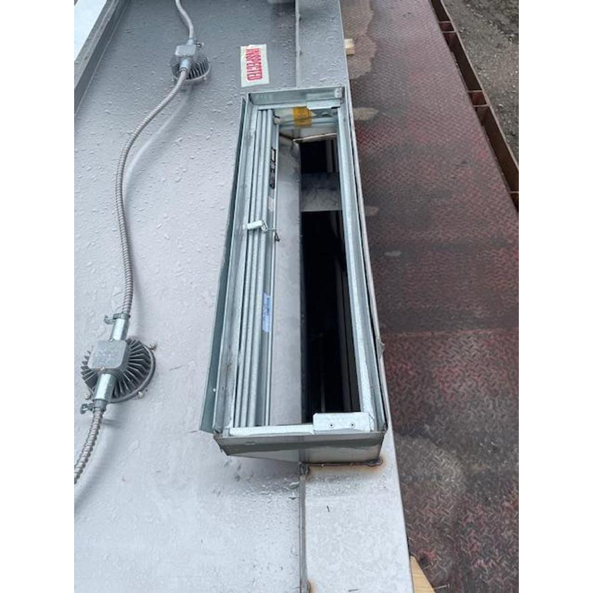 Spring Air KES-ISH commercial kitchen exhaust hood open fluorescent light fixture housing showing electrical conduit connections and interior lighting compartment detail