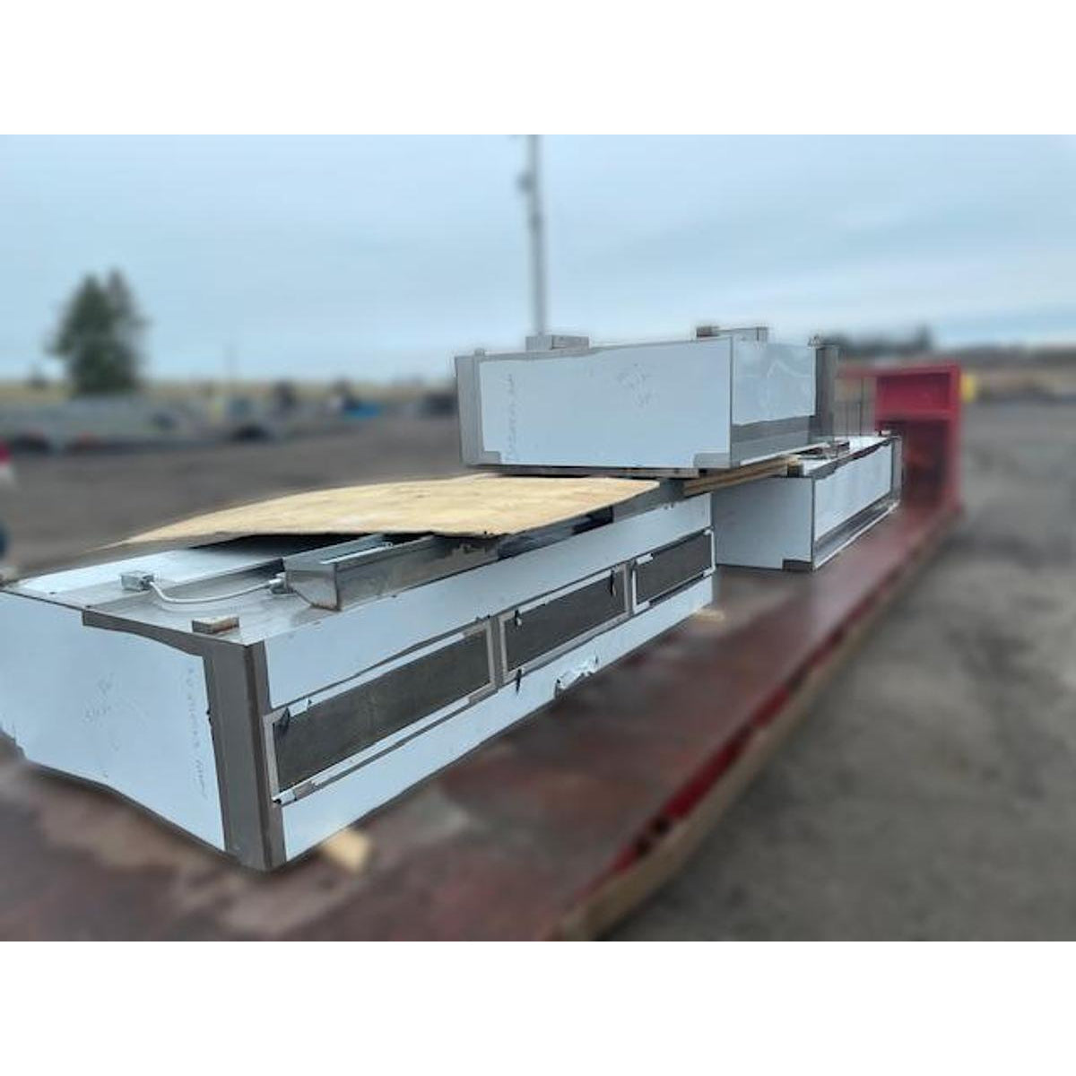 Spring Air KES-ISH stainless steel commercial kitchen exhaust hood sections on flatbed showing grease filter access doors and modular construction detail