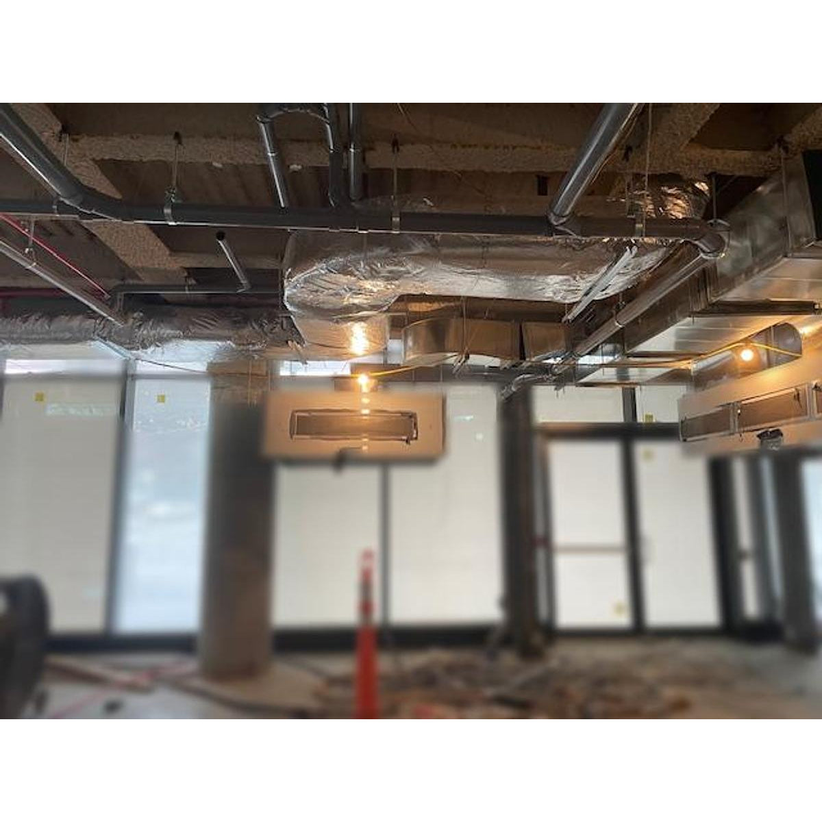 Spring Air KES-ISH commercial kitchen exhaust hood system showing insulated ductwork, plenum connections, integrated lighting, and complete ceiling-mounted ventilation installation